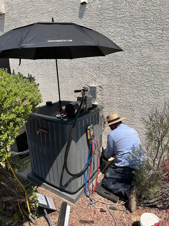HVAC technician performing outdoor AC maintenance in Pharr