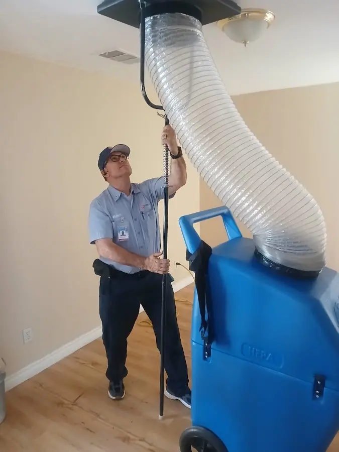 Furnace Tune-Up technician using HEPA equipment in Pharr